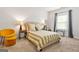 Comfortable bedroom featuring a queen-sized bed, neutral decor, and a sunny window with decorative curtains at 130 Sycamore Row, South Fulton, GA 30331