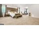 Bright, spacious bedroom features large bed with upholstered headboard and bench at the foot at 130 Sycamore Row, South Fulton, GA 30331