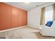 Comfortable bedroom with a stylish accent wall, soft carpet, and a cozy seating area at 130 Sycamore Row, South Fulton, GA 30331