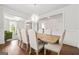 Open concept dining room showcasing hardwood floors, trim details, and a view into the living room at 130 Sycamore Row, South Fulton, GA 30331