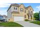 Beautiful home featuring a two-car garage, brick accents, and landscaped front yard at 130 Sycamore Row, South Fulton, GA 30331