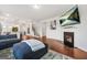 An open concept living room features hardwood floors, a fireplace, and a view into the kitchen at 130 Sycamore Row, South Fulton, GA 30331