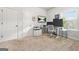 Bright office with a large monitor, desk, printer, cabinets, and natural light from a window at 130 Sycamore Row, South Fulton, GA 30331