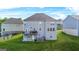 Two-story home showcasing a spacious backyard with well-maintained lawn and deck at 130 Sycamore Row, South Fulton, GA 30331