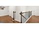 Interior view of a home staircase featuring hardwood steps and a decorative metal and wood railing at 130 Sycamore Row, South Fulton, GA 30331