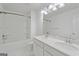 Clean bathroom featuring double sinks, tub-shower combo, and white fixtures at 1953 Azure Grove Ct, Marietta, GA 30008