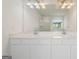 Bright bathroom featuring double sinks, large mirror, and natural lighting at 1953 Azure Grove Ct, Marietta, GA 30008