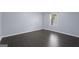 Clean bedroom with sleek wood flooring and a bright window offers a modern feel at 1953 Azure Grove Ct, Marietta, GA 30008