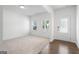 Bright living room with neutral carpet, lots of natural light, and hardwood entryway at 1953 Azure Grove Ct, Marietta, GA 30008