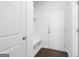 Mudroom with a white storage bench and coat hooks by the front door for easy organization at 1953 Azure Grove Ct, Marietta, GA 30008