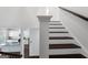 Staircase with oak treads and white risers leads to an open floorplan and eat-in kitchen at 1953 Azure Grove Ct, Marietta, GA 30008