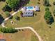 Sprawling estate featuring a home with a pool, garage, and ample green space surrounded by trees at 421 Hampton Rd, Fayetteville, GA 30215