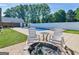 Backyard pool area with chairs and fire pit perfect for entertaining friends and Gathering at 421 Hampton Rd, Fayetteville, GA 30215
