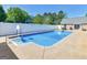 Backyard in-ground pool features basketball goal, steps and concrete surround at 421 Hampton Rd, Fayetteville, GA 30215
