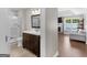 Bathroom features a modern vanity with a dark wood cabinet, a bright white countertop, and a glass-enclosed shower at 421 Hampton Rd, Fayetteville, GA 30215
