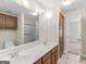 Bathroom featuring double sink vanity with framed mirror and wooden cabinets at 421 Hampton Rd, Fayetteville, GA 30215