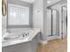 Bright bathroom featuring a luxurious soaking tub, walk-in shower, and tile flooring at 421 Hampton Rd, Fayetteville, GA 30215
