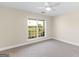 Bright bedroom with neutral walls, ceiling fan, a window, and carpet at 421 Hampton Rd, Fayetteville, GA 30215