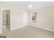 Bright bedroom with neutral walls, ceiling fan, a window, and carpet at 421 Hampton Rd, Fayetteville, GA 30215
