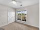 Bright bedroom features a ceiling fan, a double-door closet, and a large window with outdoor views at 421 Hampton Rd, Fayetteville, GA 30215