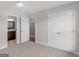 Bright bedroom with neutral carpet, white trim, and large double-door closet at 421 Hampton Rd, Fayetteville, GA 30215