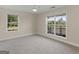 Bright bedroom featuring two large windows that offer ample natural light and picturesque outdoor views at 421 Hampton Rd, Fayetteville, GA 30215