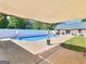 In-ground pool under covered patio with basketball goal in backyard, perfect for a relaxing outdoor living space at 421 Hampton Rd, Fayetteville, GA 30215