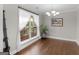 Bright dining room featuring wood floors, a chandelier, and a large window that offers abundant natural light at 421 Hampton Rd, Fayetteville, GA 30215