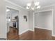A view from the dining room shows the kitchen, which features white cabinets and stainless steel appliances at 421 Hampton Rd, Fayetteville, GA 30215