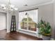 Bright dining room featuring wood floors, a chandelier, and a large window that offers abundant natural light at 421 Hampton Rd, Fayetteville, GA 30215