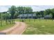 Inviting home with a gravel driveway, fenced yard, and charming porch, perfect for a peaceful retreat at 421 Hampton Rd, Fayetteville, GA 30215