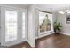 Bright foyer with a beautiful front door and a lovely cactus in the living room window at 421 Hampton Rd, Fayetteville, GA 30215