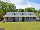 Beautiful brick home with a classic front porch and manicured landscaping, perfect for curb appeal at 421 Hampton Rd, Fayetteville, GA 30215