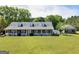 Charming brick home with a white picket fence, inviting porch, and well-manicured front lawn at 421 Hampton Rd, Fayetteville, GA 30215