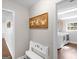 Hallway leading to the laundry room featuring decorative artwork and a bench at 421 Hampton Rd, Fayetteville, GA 30215