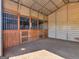 Spacious interior of a well-ventilated horse stall, featuring wooden doors and metal bars at 421 Hampton Rd, Fayetteville, GA 30215