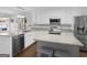 A bright kitchen featuring stainless steel appliances and granite countertops, and views to the backyard pool at 421 Hampton Rd, Fayetteville, GA 30215