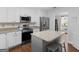 A view of the kitchen with stainless steel appliances, stone countertops and lots of white cabinets at 421 Hampton Rd, Fayetteville, GA 30215