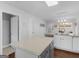 A bright kitchen featuring a stone island countertop, stainless steel appliances and lots of white cabinets at 421 Hampton Rd, Fayetteville, GA 30215