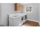 Well-equipped laundry room with modern washer and dryer units and ample storage space at 421 Hampton Rd, Fayetteville, GA 30215