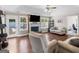 Cozy living room featuring a brick fireplace, TV, and views of the outdoor pool at 421 Hampton Rd, Fayetteville, GA 30215