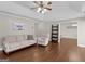 Inviting living room with hardwood floors, a comfortable sofa and armchair, and an adjacent dining area at 421 Hampton Rd, Fayetteville, GA 30215