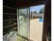 View from garage through sliding door to back yard and pool with patio furniture at 421 Hampton Rd, Fayetteville, GA 30215