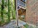 Brick house with walkout basement and wooden deck overlooking a lush backyard with a line of trees at 143 Tara Blvd, Loganville, GA 30052