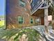Brick home exterior with a covered patio area, perfect for outdoor relaxation and entertainment at 143 Tara Blvd, Loganville, GA 30052