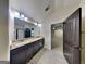 Bathroom boasts double sinks, granite counters, a walk-in shower, and a door leading to main bedroom at 143 Tara Blvd, Loganville, GA 30052