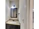 Bathroom featuring a granite countertop, sink, and framed mirror at 143 Tara Blvd, Loganville, GA 30052