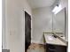 Bathroom featuring a granite countertop, sink, and dark wood door at 143 Tara Blvd, Loganville, GA 30052
