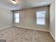 Bedroom with carpet flooring and two windows provides ample natural light at 143 Tara Blvd, Loganville, GA 30052