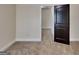 Bedroom featuring carpet flooring and a dark-stained wooden door with raised panels at 143 Tara Blvd, Loganville, GA 30052